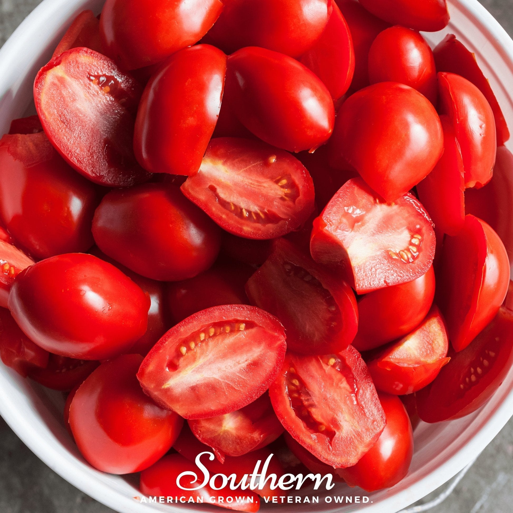 Sliced red tomatoes in a white bowl with 'Southern' brand logo.