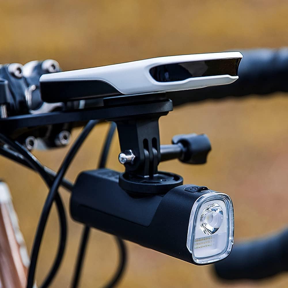 Bicycle handlebar with light and camera mount on a blurred background