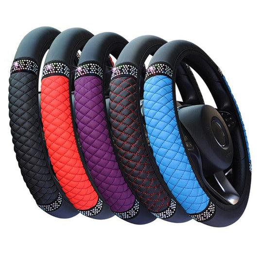 Set of colorful quilted steering wheel covers with rhinestone trim on a white background