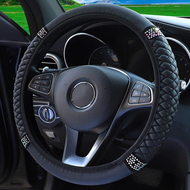 Steering wheel cover with decorative elements on a car steering wheel