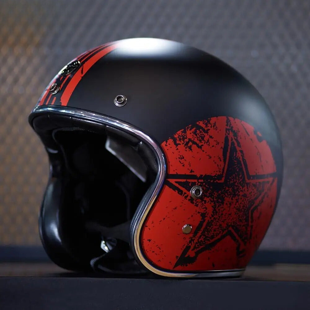 Black and red helmet with star design on a dark background