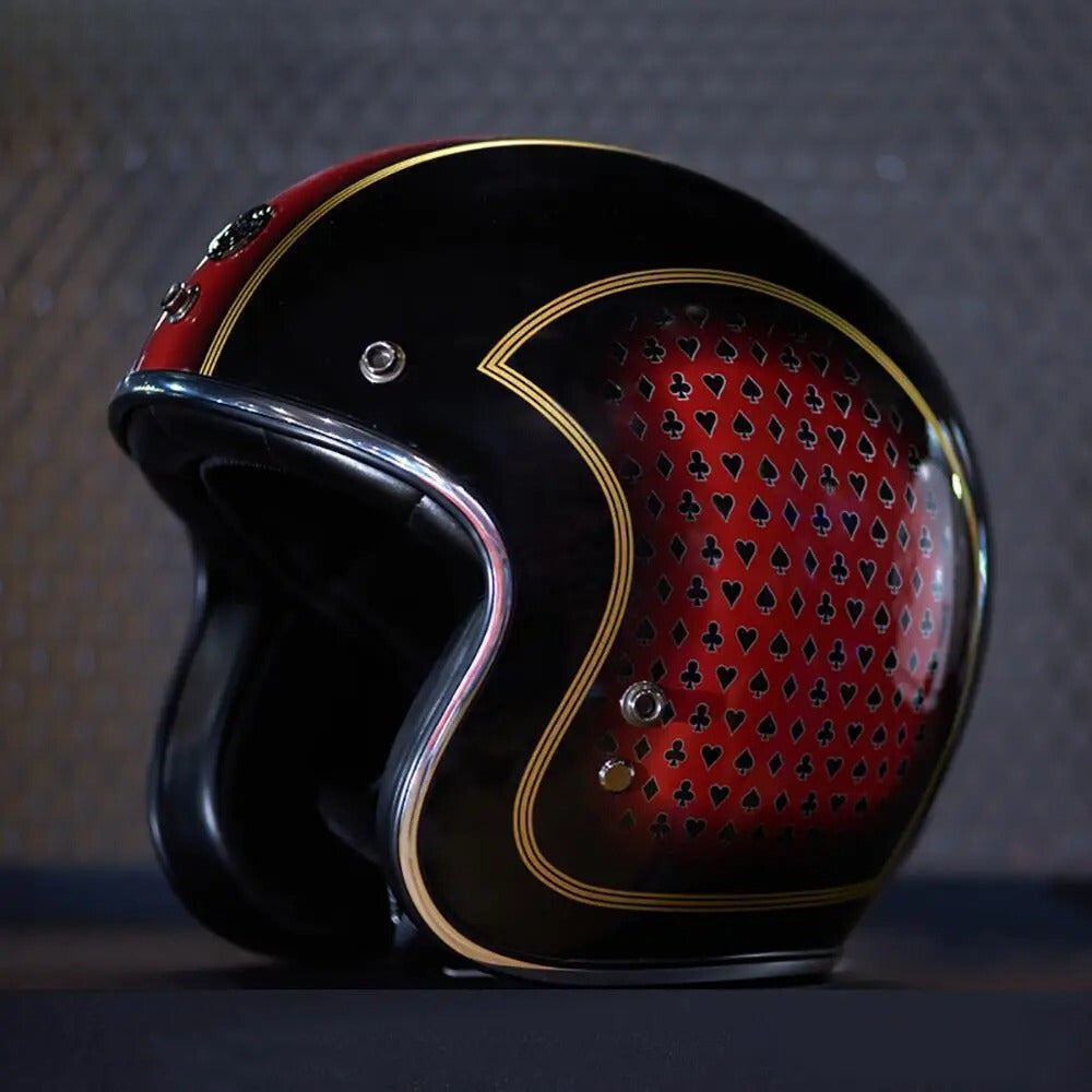 Black and red motorcycle helmet with patterned visor on a dark background