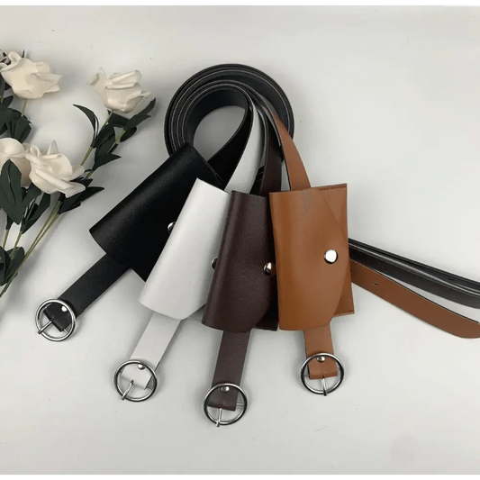 Set of leather belts in black, white, brown, and tan on a light gray background with flowers.
